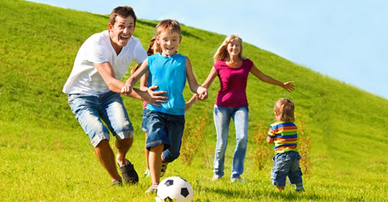 Parents playing soccer with their children