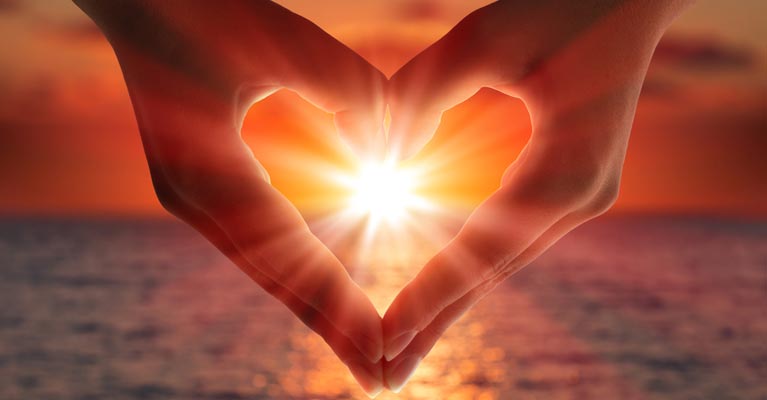 Image of the sun through hands